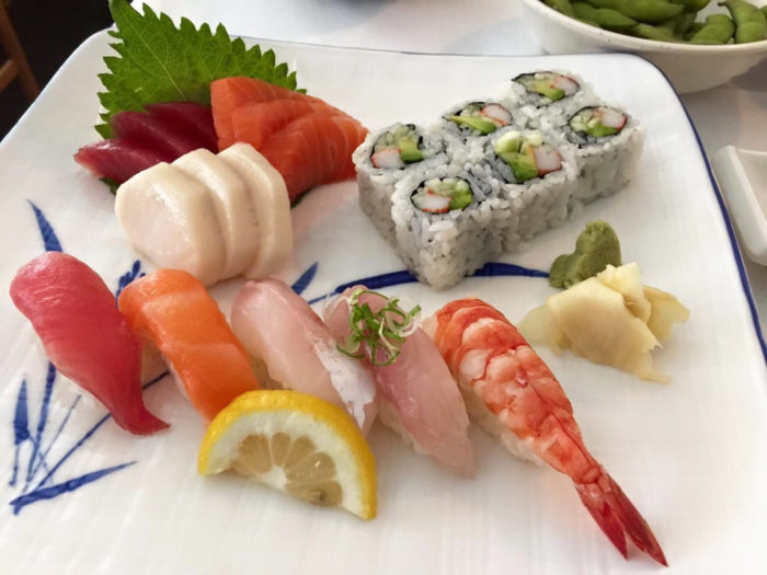Sushi, sashimi and rolls on a plate.
