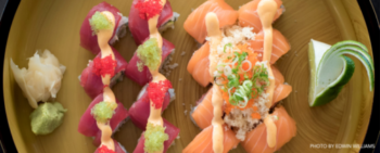 Sushi rolls on a wooden plate.